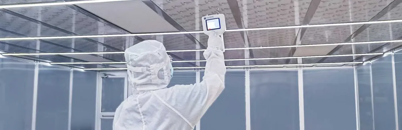 Technician testing a FastIns modular cleanroom ceiling at the Airkey factory