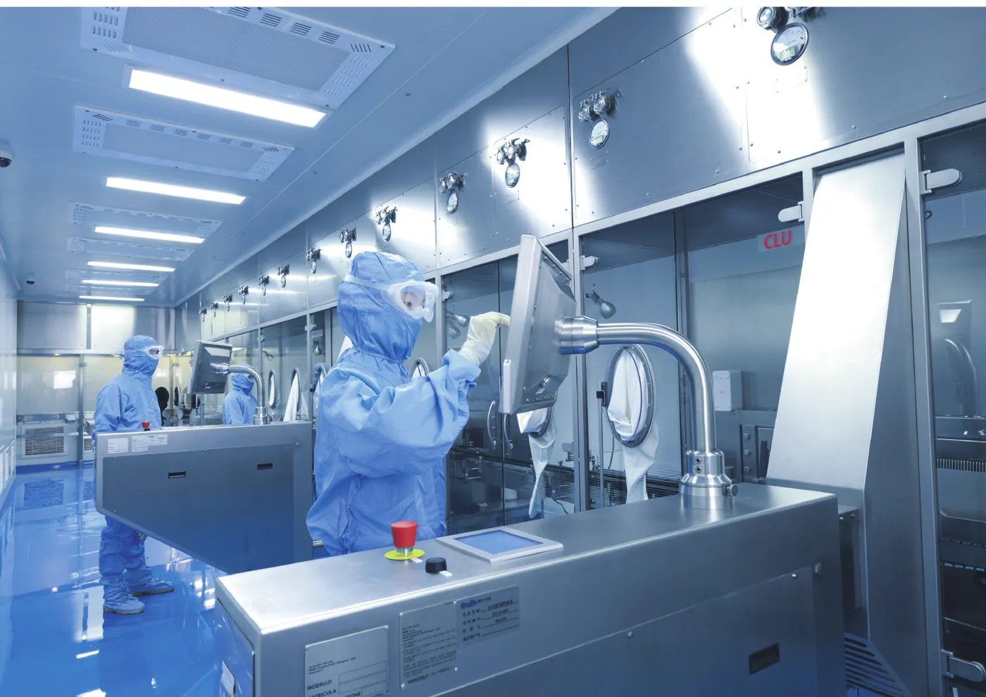 Operator working under an Airkey laminar flow hood in a pharmaceutical cleanroom